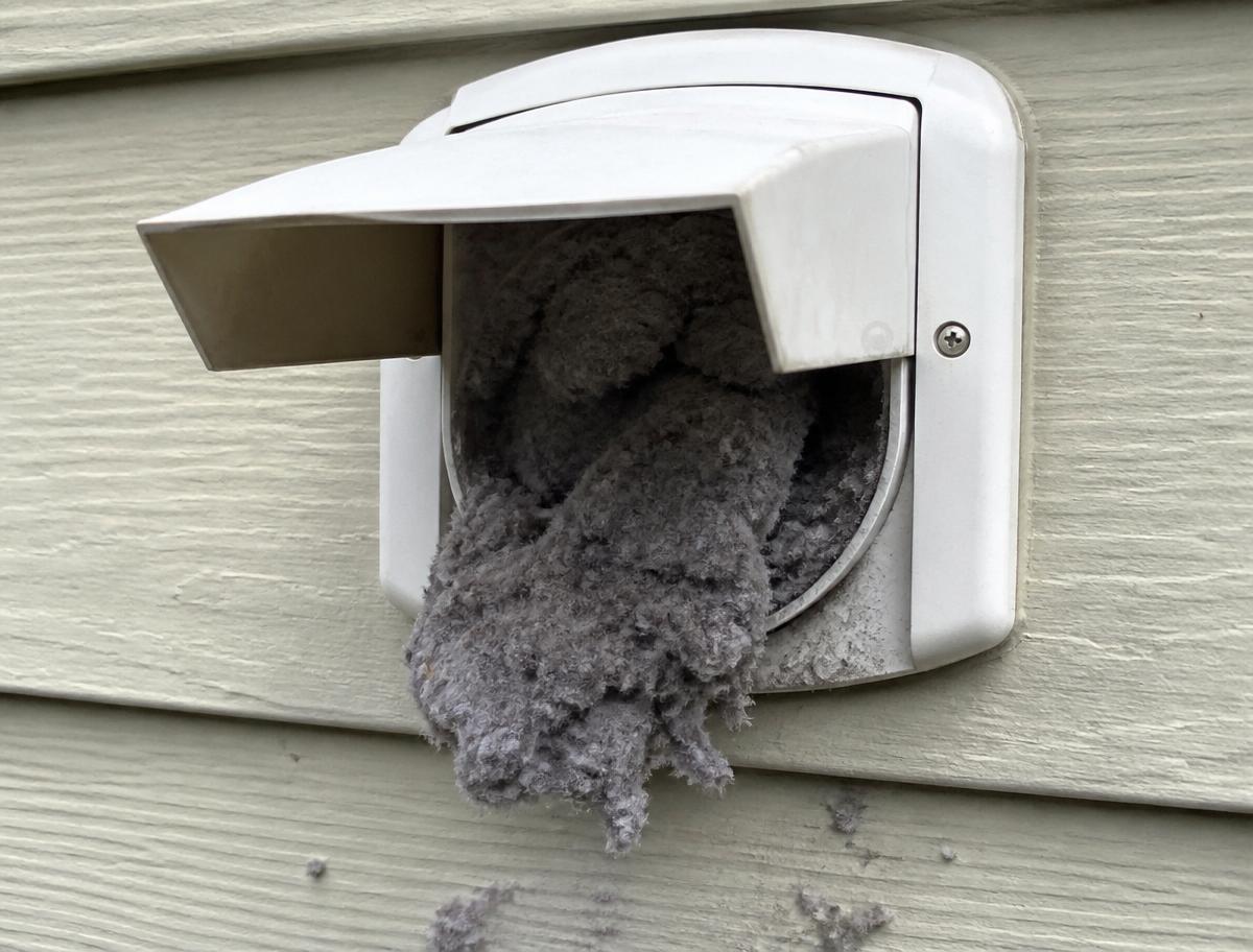 Exterior dryer vent hood packed with lint before cleaning